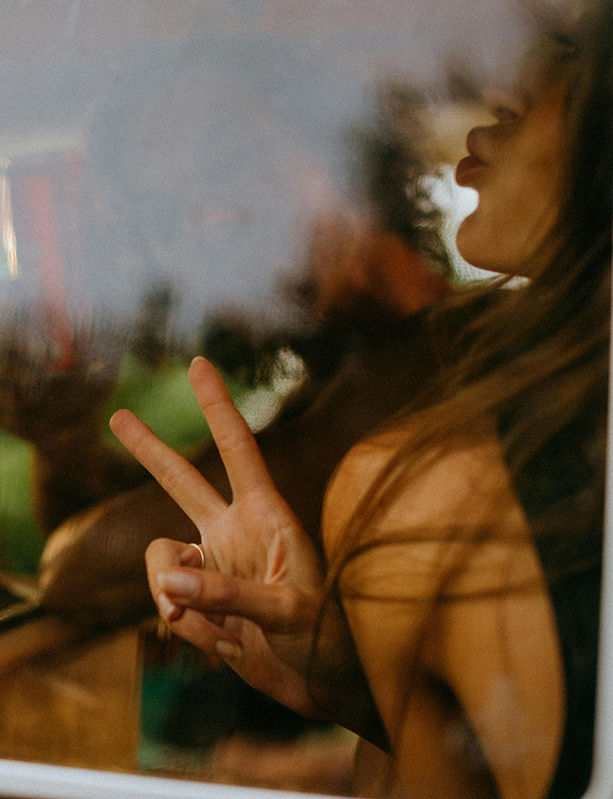 Close up on girl smiling behind glass