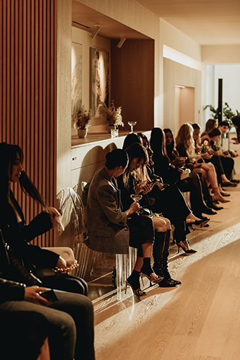 People sitting at a fashion show at Fifteen Fifteen in Vancouver