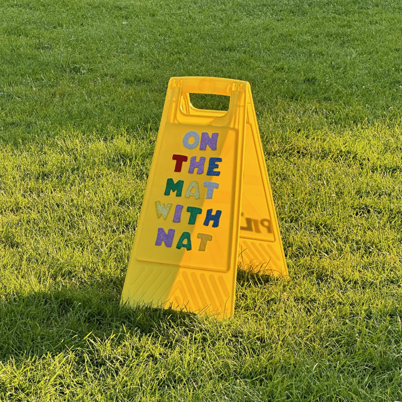 Yellow sign on the grass
