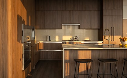 A kitchen in moody lighting and a darker wood colour scheme