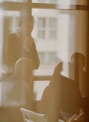 People in a boardroom through glass