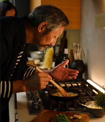 Man cooking over a pot