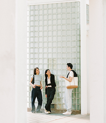 People leaning against a wall while chatting