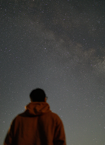 Man looking up at stars