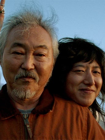 Picture of two people smiling at camera