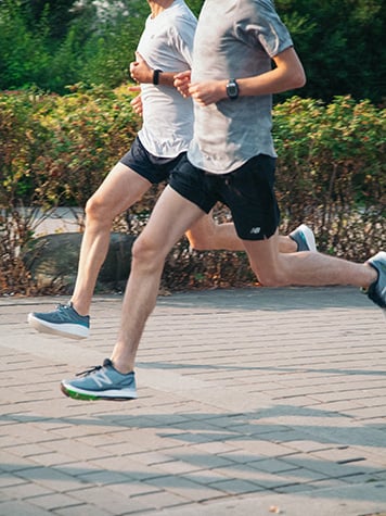 Two men running in Surrey