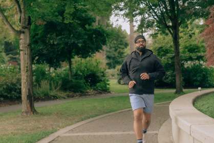 A man going for a run in the park. 