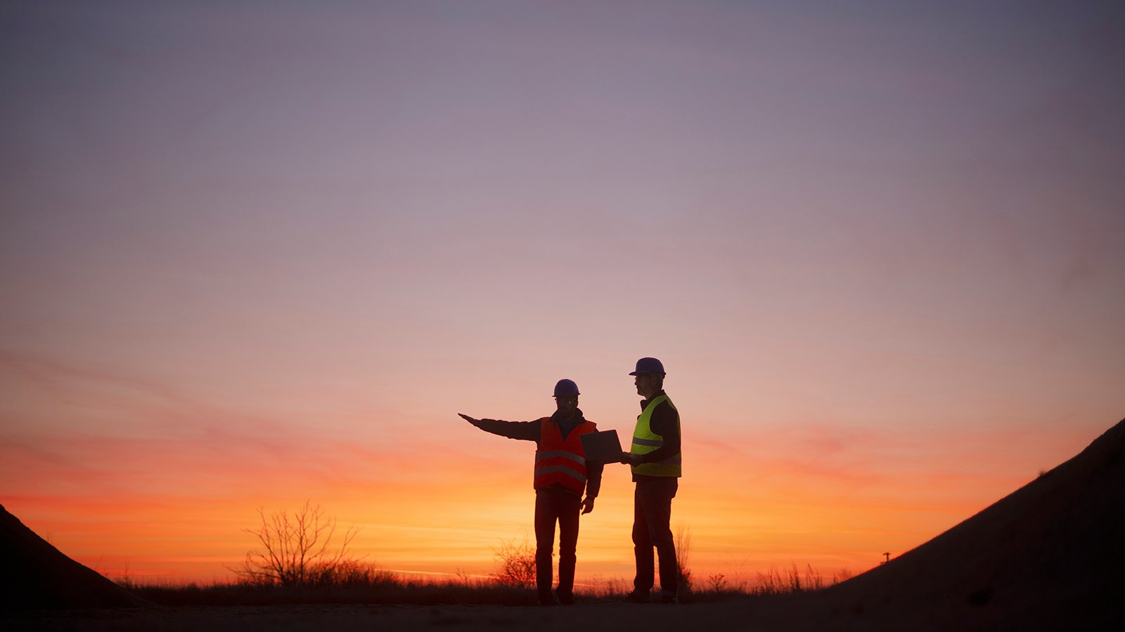 construction workers at sunset