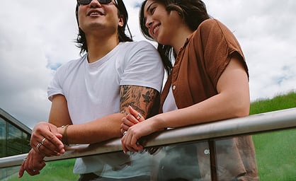 Girl and guy looking over balcony