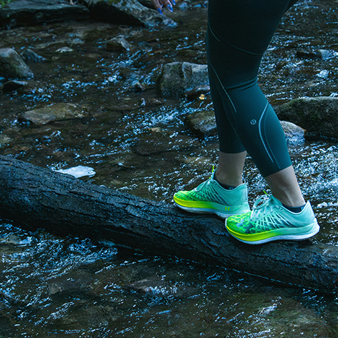 Girl walking across a log