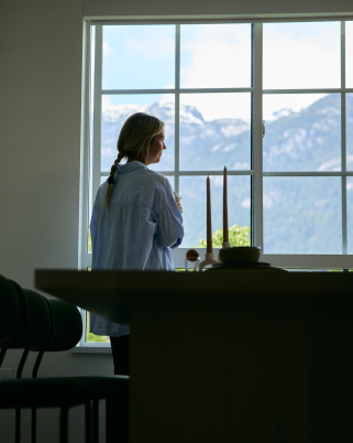 Lady looking out the window looking at mountains