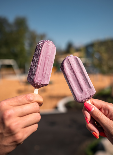Two hands holding popsicles