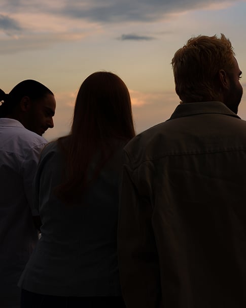 People facing towards the sunset