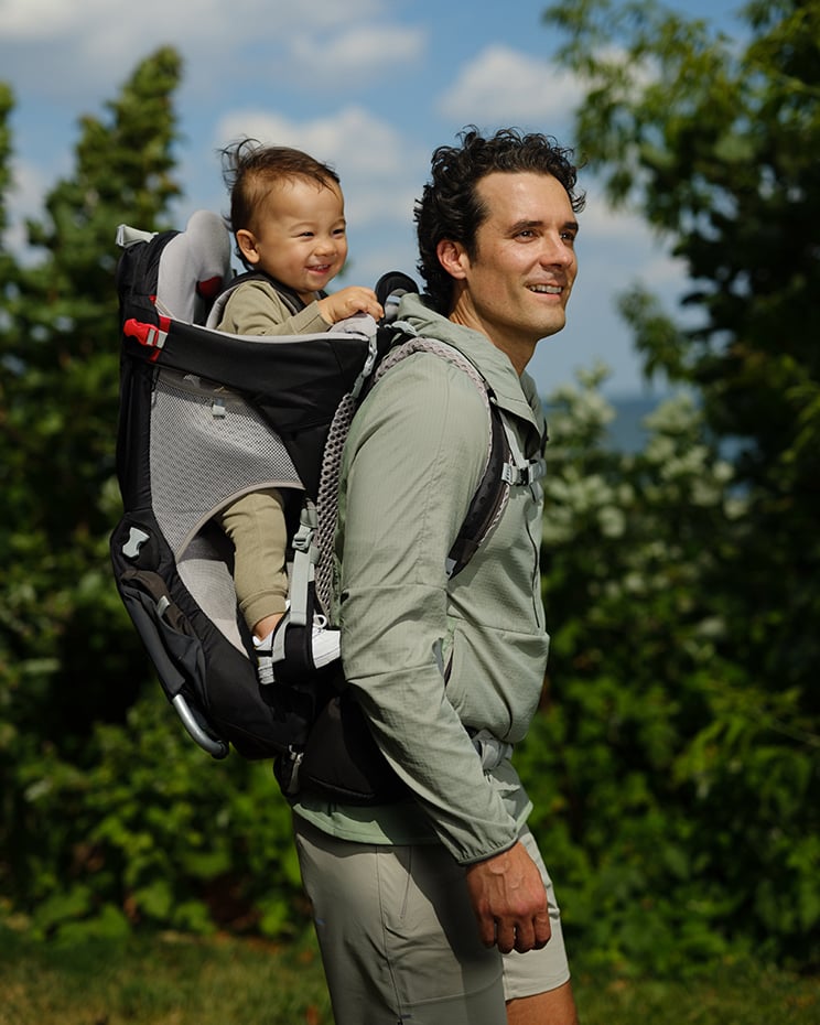 Man carrying child on his back