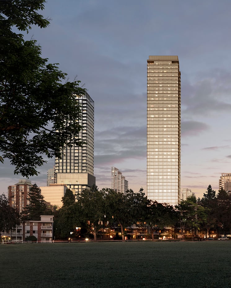 Two towers peak out from behind greenery in Burnaby's Central Park District with a moody sky behind