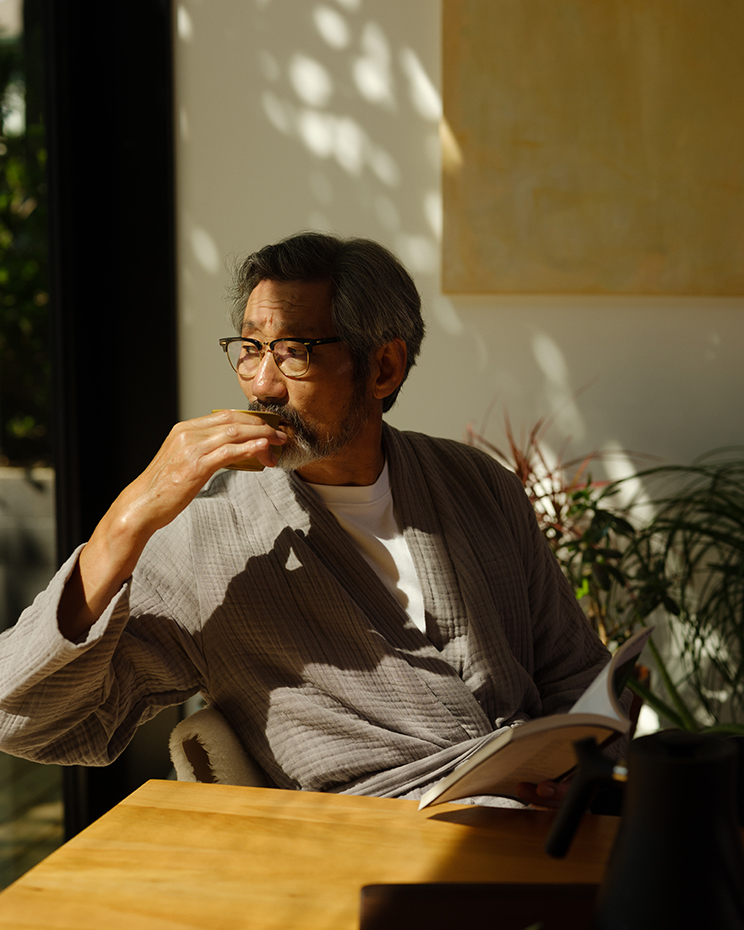 Man sitting in sunlight at desk