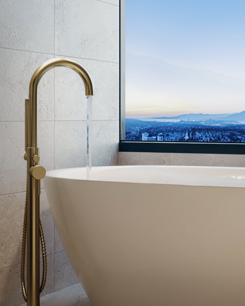 Close up of a 24k gold bathtub with a window overlooking Burnaby