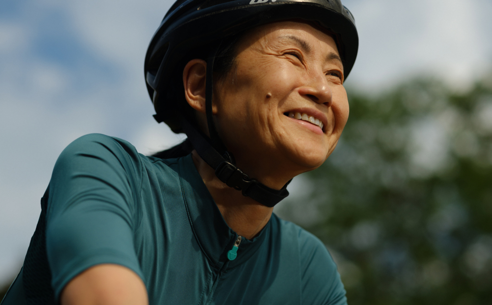 Man smiling while riding bicycle