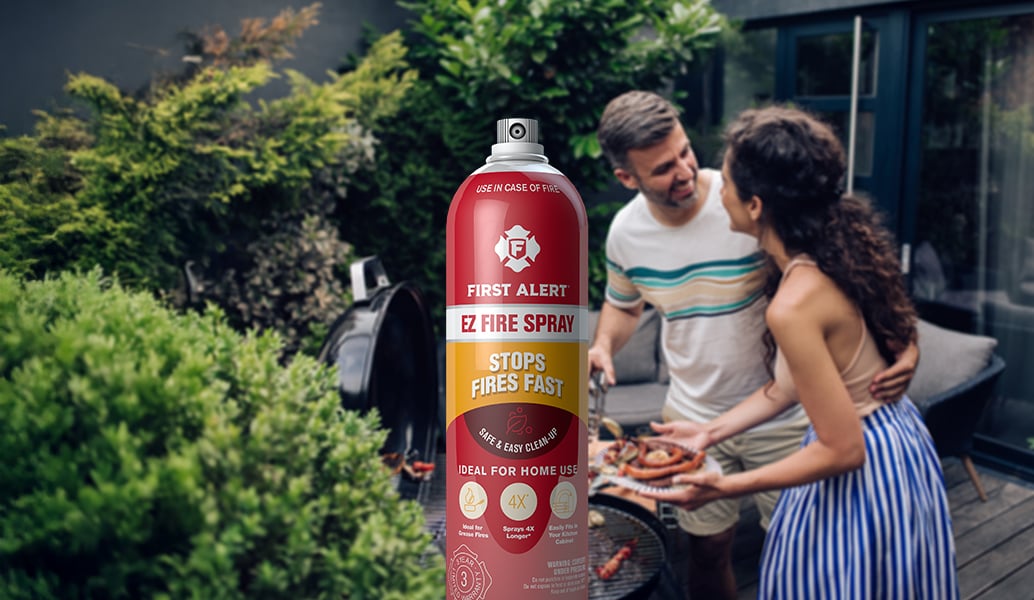 EZ Fire Spray with couple grilling in background 
