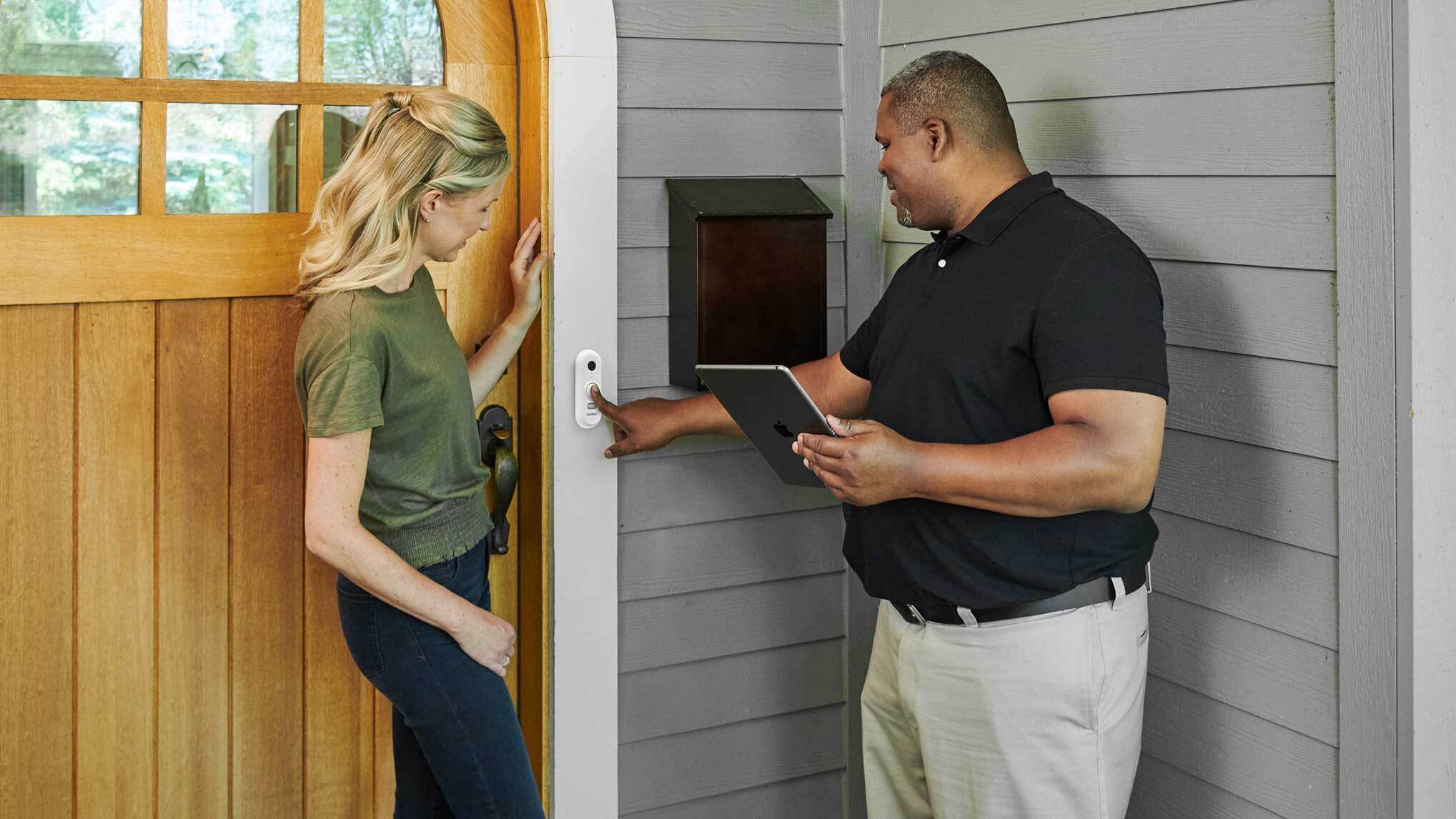 A professional installer points to a First Alert Smart Wifi Video Doorbell