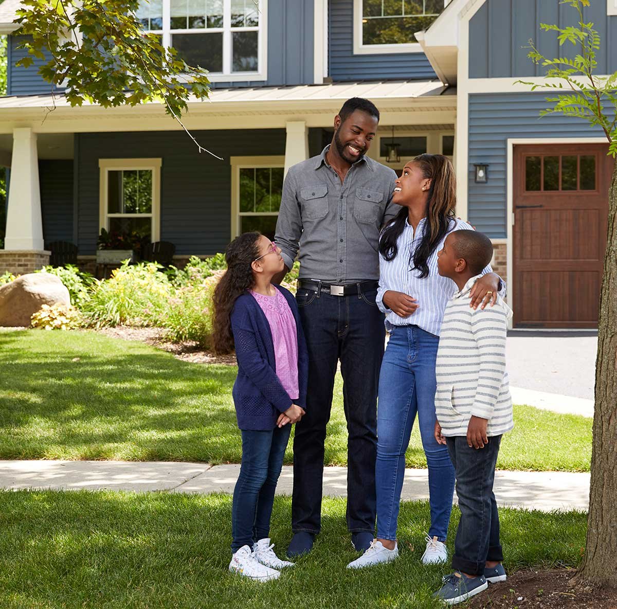 A family gathering in front of a house. 