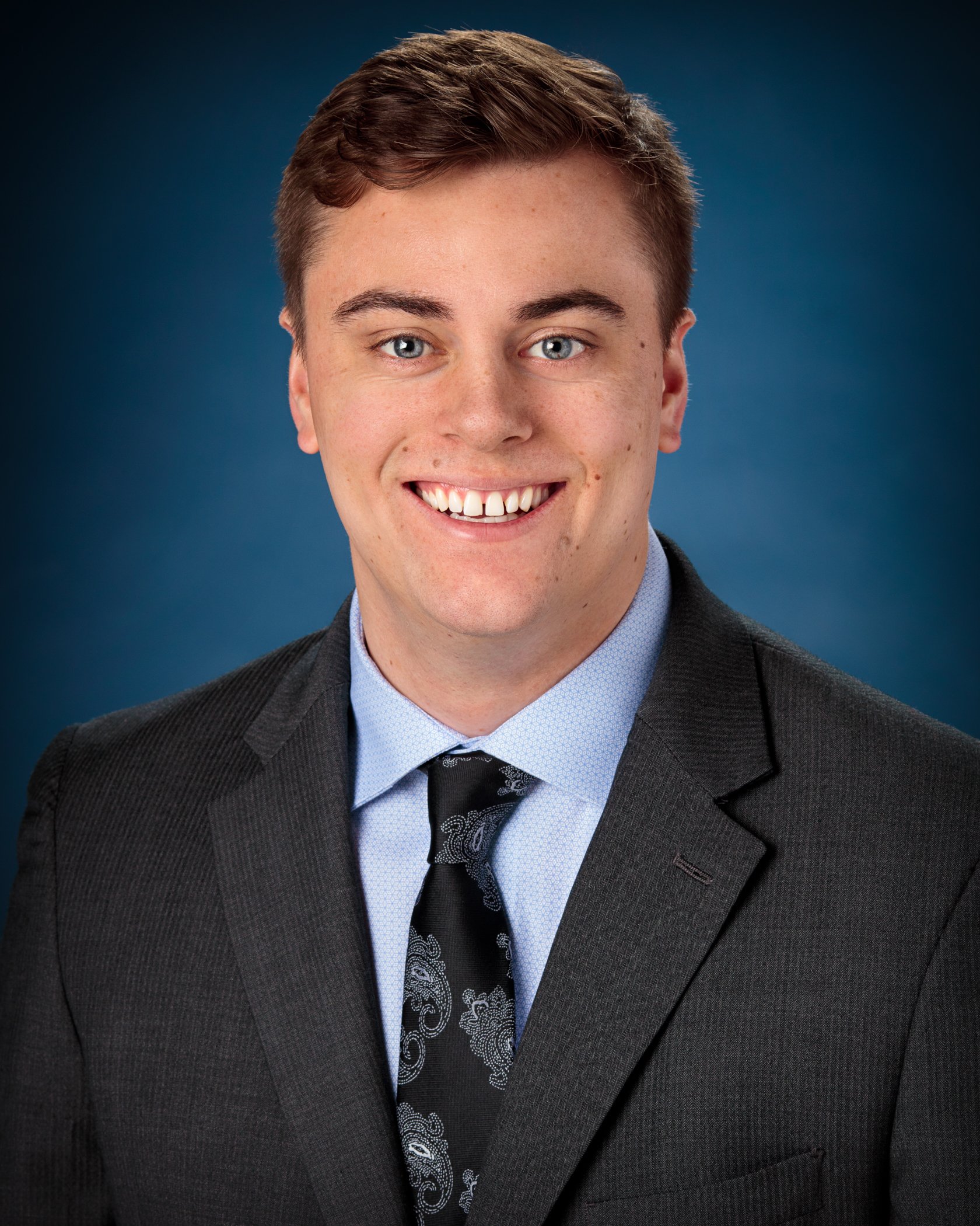 a man in a suit smiling