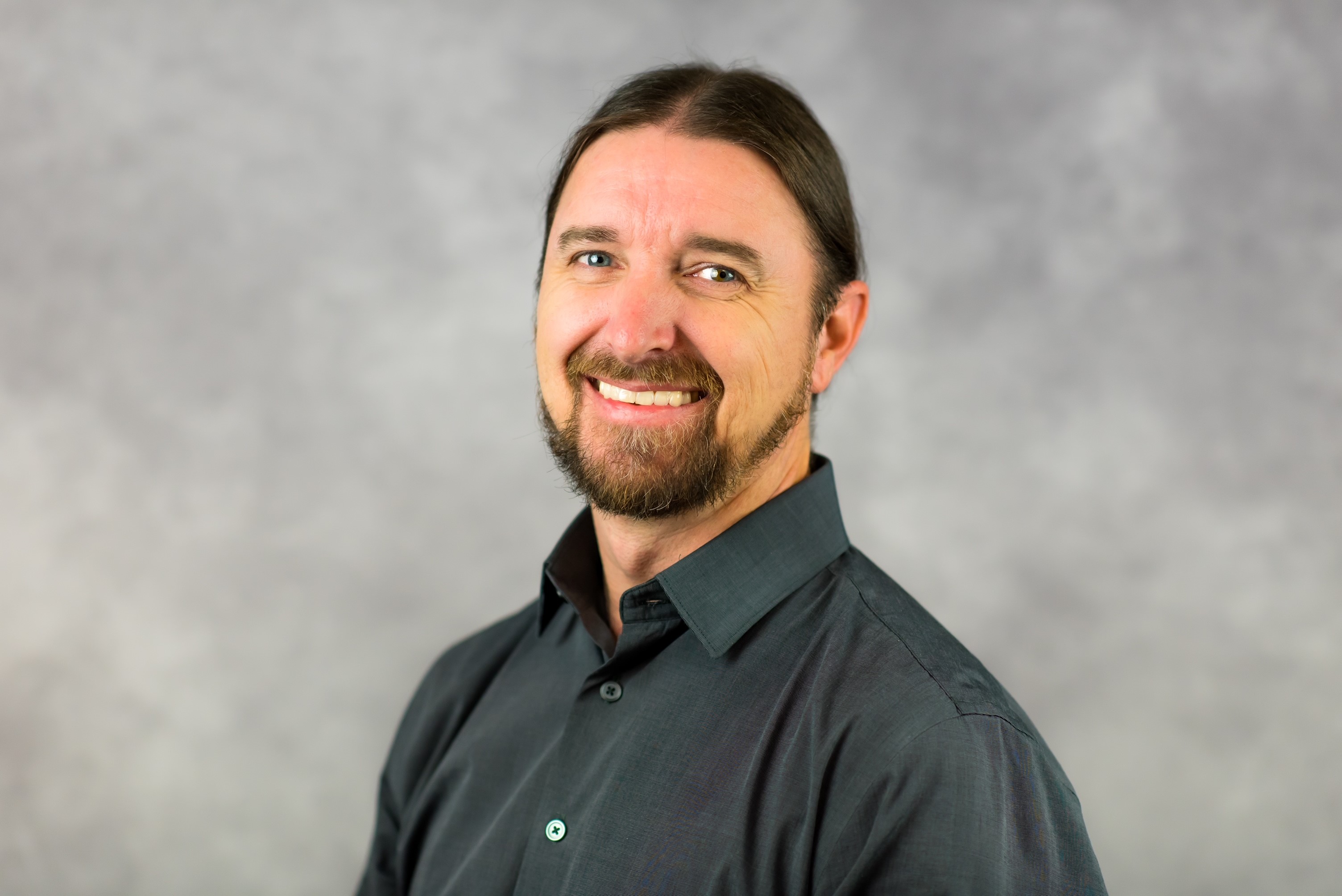 a man with a beard smiling