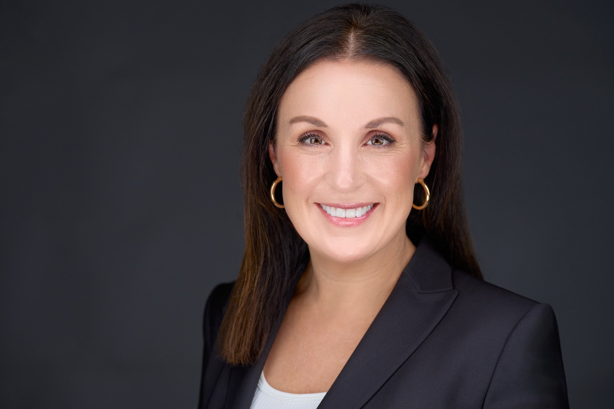 a person with earrings smiling