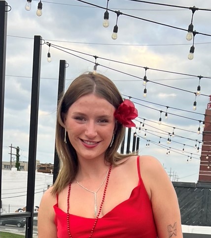 a woman with a red flower in her hair