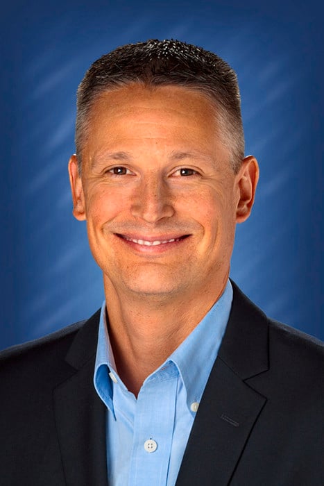 a man in a suit smiling