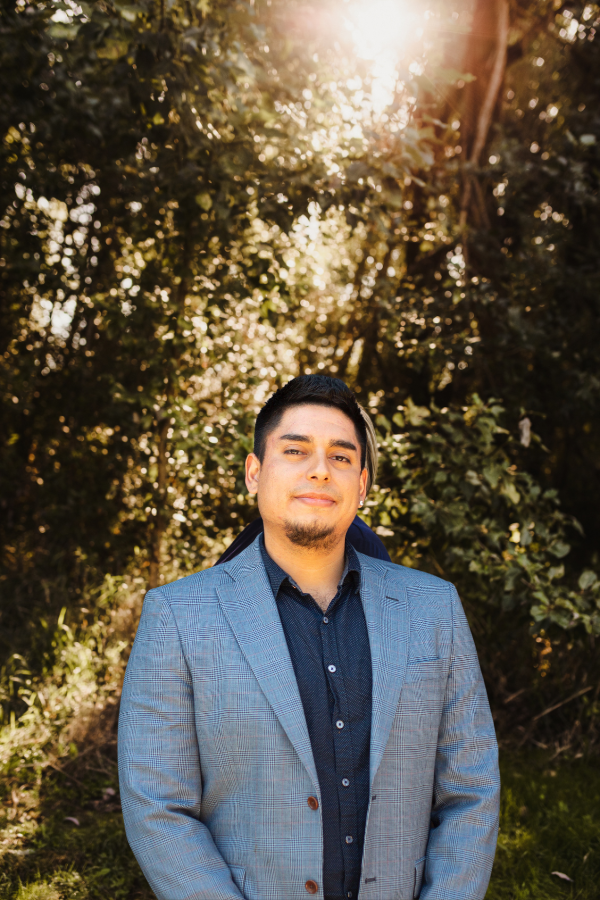 a man standing in front of a tree
