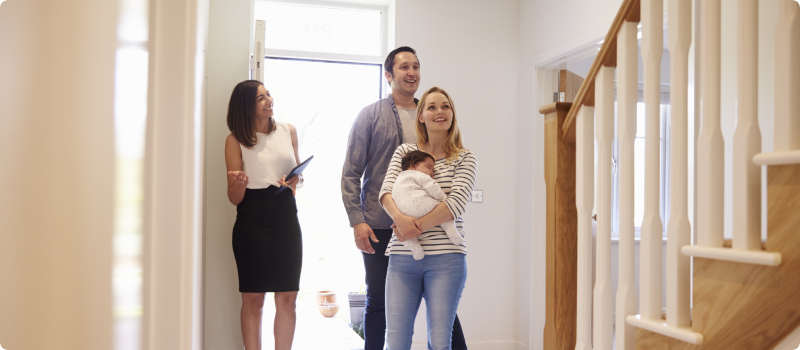 Realtor showing a young family a property for sale