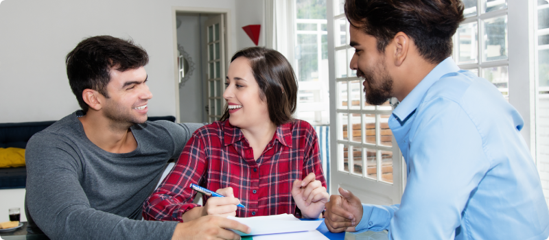 man and woman signing papers for their new home