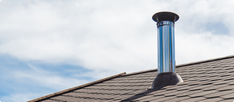 Chimney pipe from stainless steel on the roof of the house