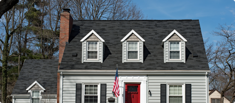 Cape Cod House with Three Dormers & Red Door