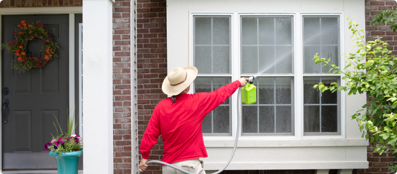 a person washing their house's windows