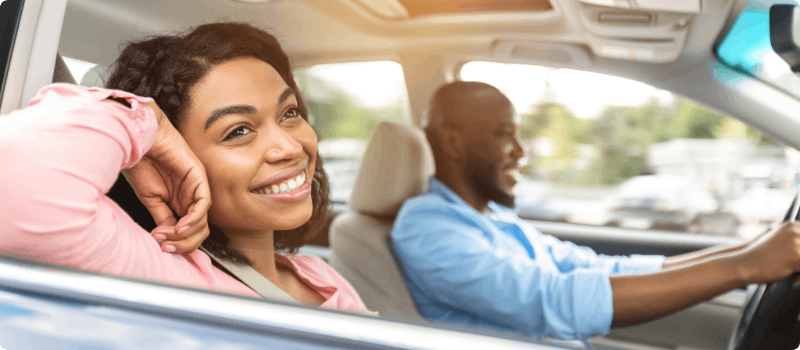 Two happy people going for a drive.