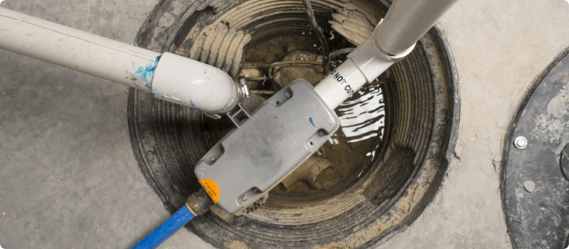 A sump pump installed in a home basement.