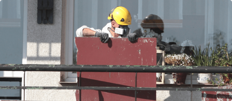 Worker removing asbestos from a home.