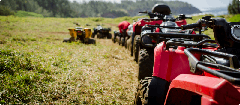 A line of ATVs in a field.