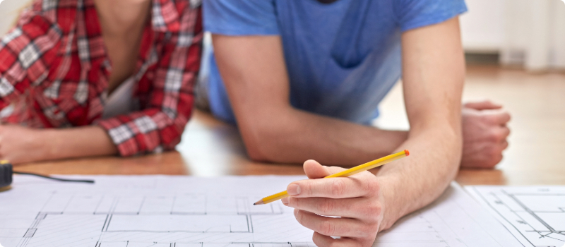 A couple reviewing them home's blueprints.