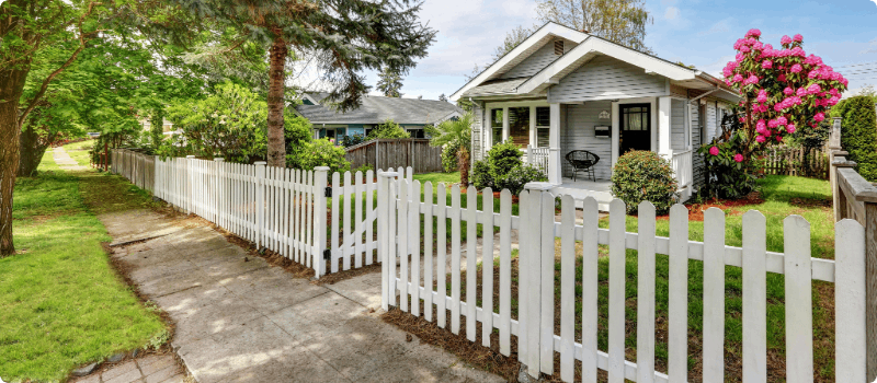 House with a white picket fence. 