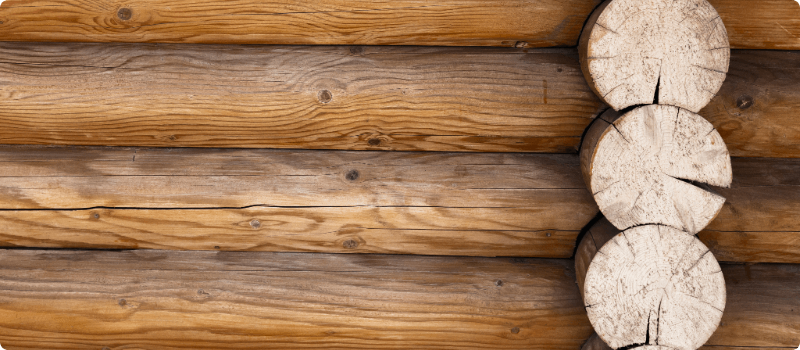Close-up of logs on the side of a log cabin. 