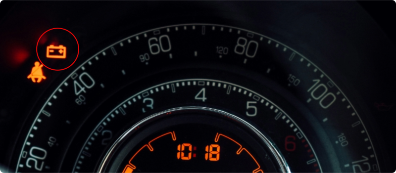 A close-up of a yellow check engine light on a car's dashboard.