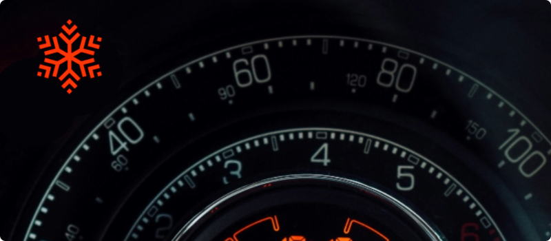 A close-up of a car's dashboard featuring a frost warning light illuminated.  