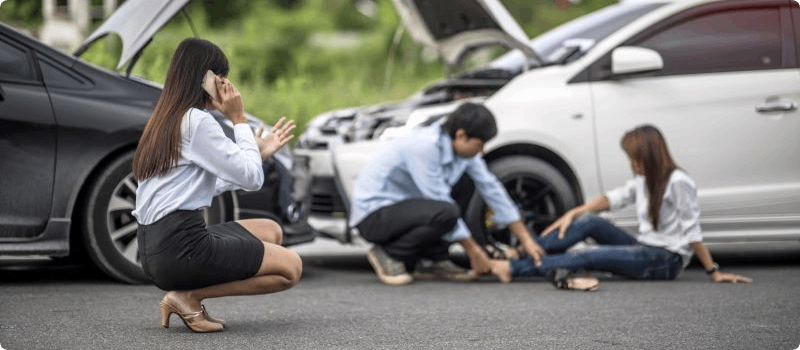 People assessing the scene of a car accident. 