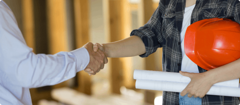 A contractor and client shaking hands.