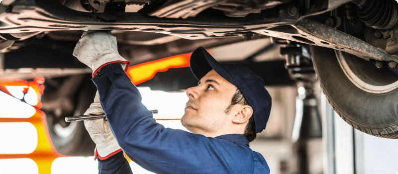 Mechanic working on car. 