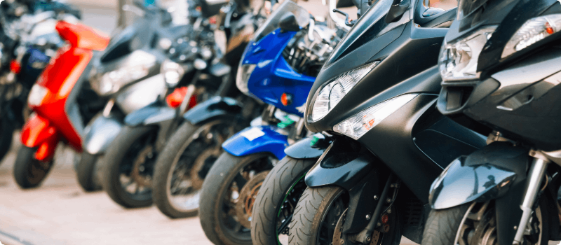 A row of new scooters and mopeds.