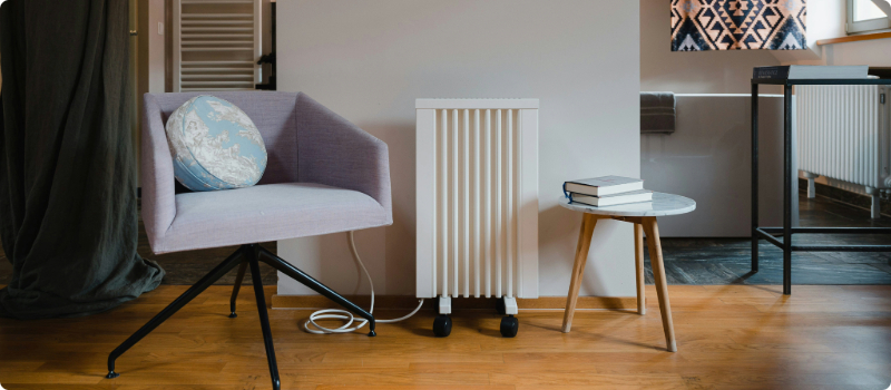 A small, portable electric heater in a living room.